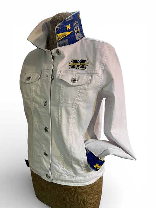 White denim jacket with Michigan Wolverines logo