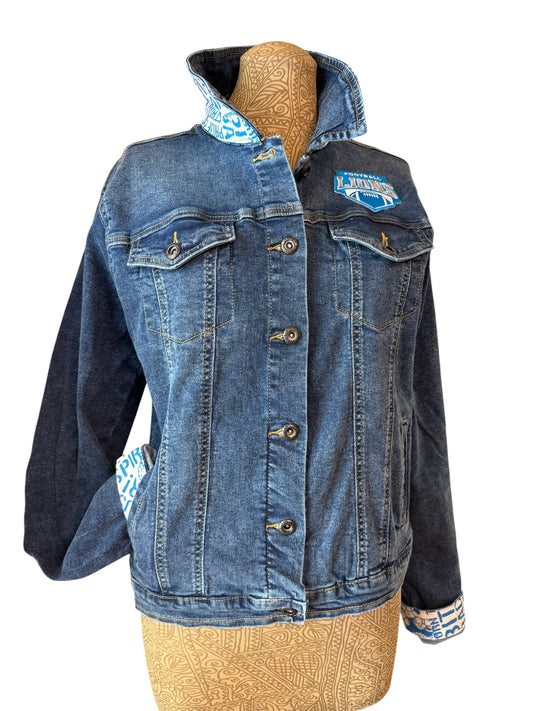 A women's denim jacket with contrasting dark navy sleeves and a light blue patterned lining on the collar, cuffs, and pockets, displayed on a tan mannequin torso against a white background.