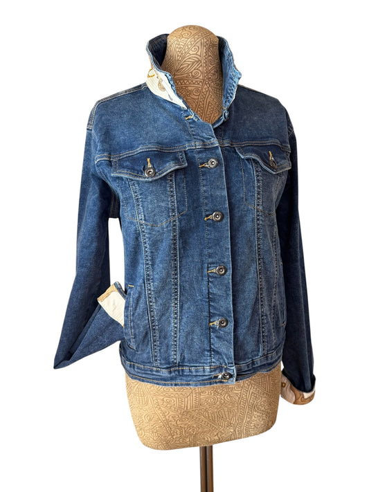 A blue denim jacket displayed on a tan dress form mannequin against a plain white background.
