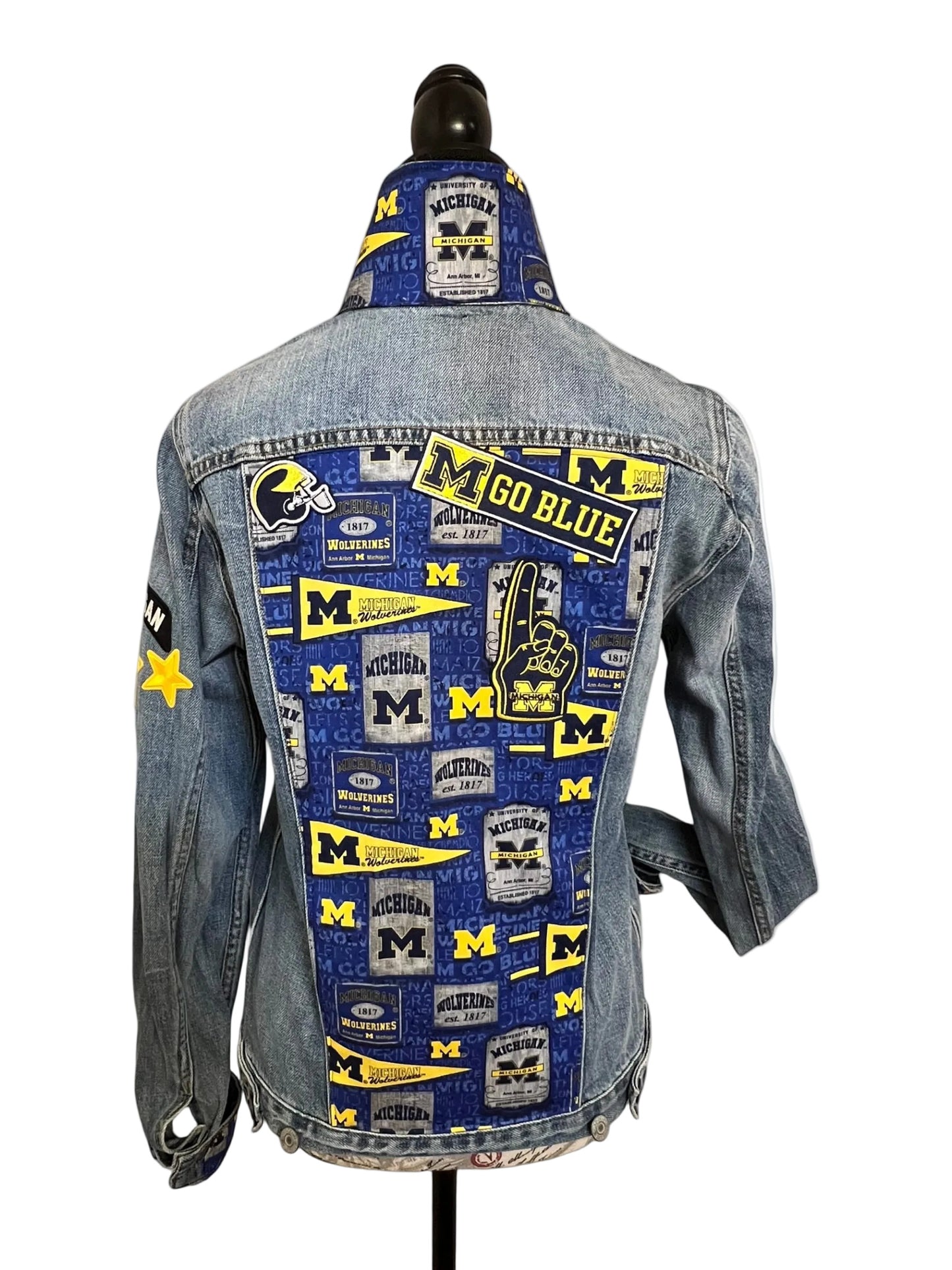 Denim jacket with Michigan Wolverines patches 