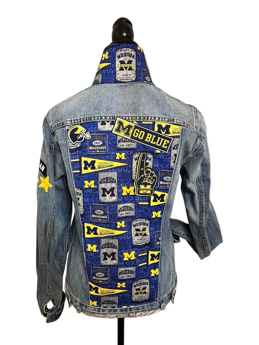 Denim jacket with Michigan Wolverines patches 