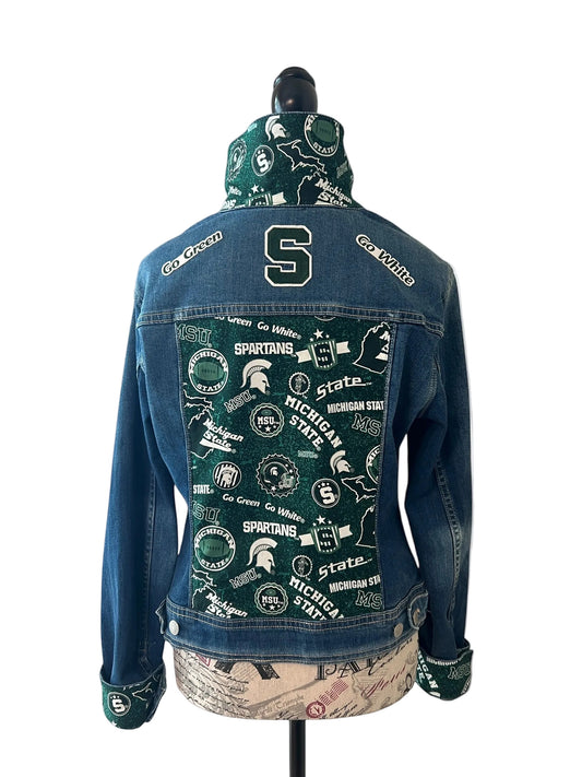 Blue denim jacket with various logos and text 