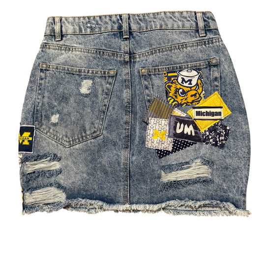 Denim skirt with patches and frayed edges 