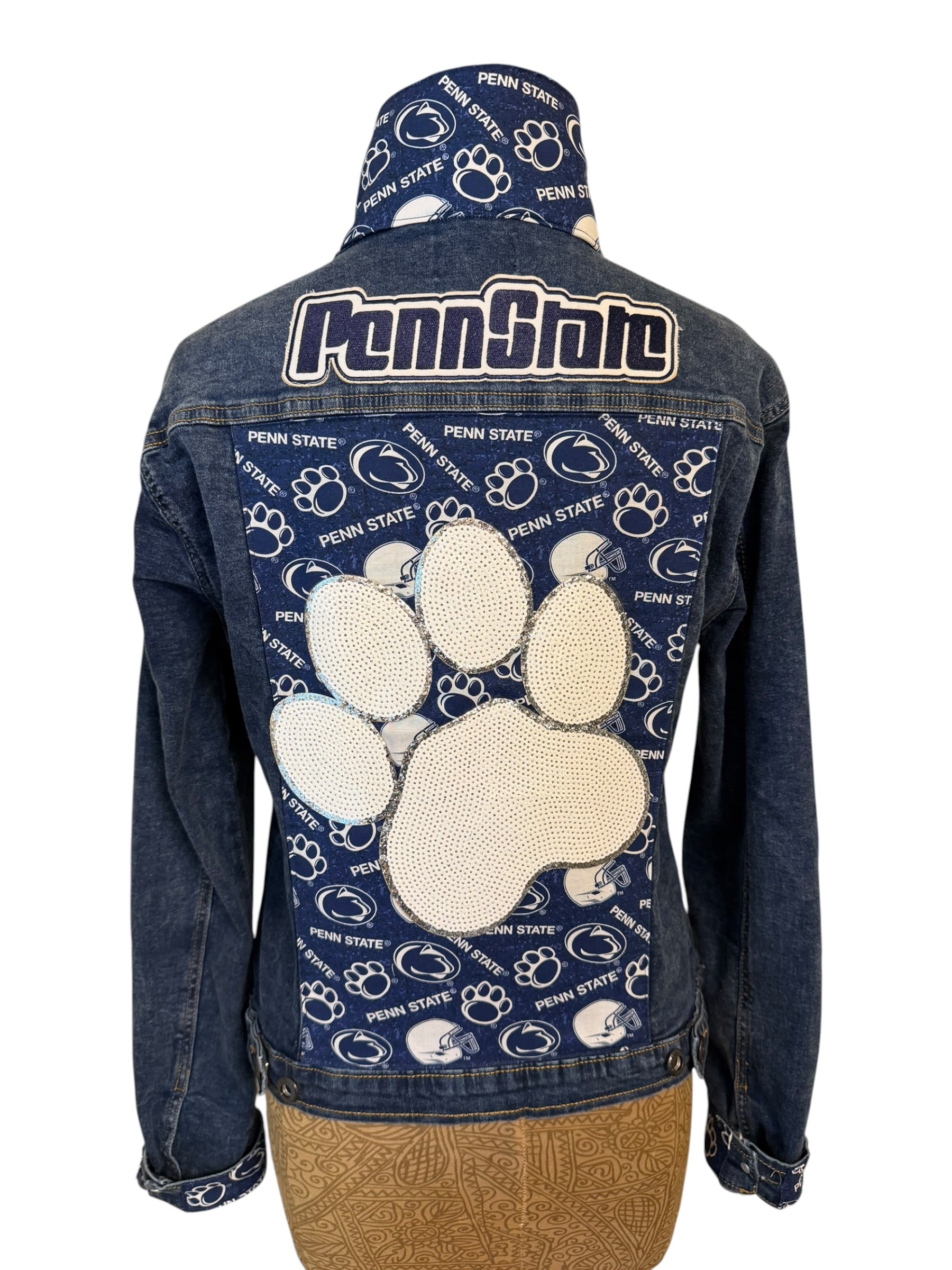 Denim jacket with Penn State logo and paw print design on a white background