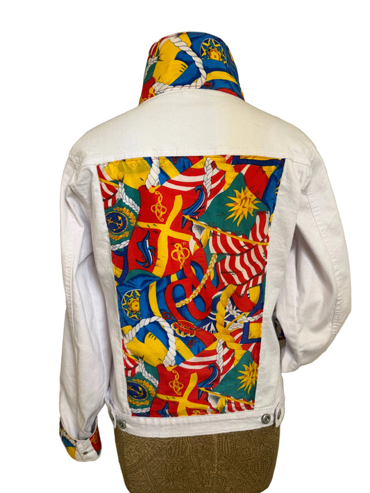 Colorful patterned pouch attached to a white bag with a beige background
